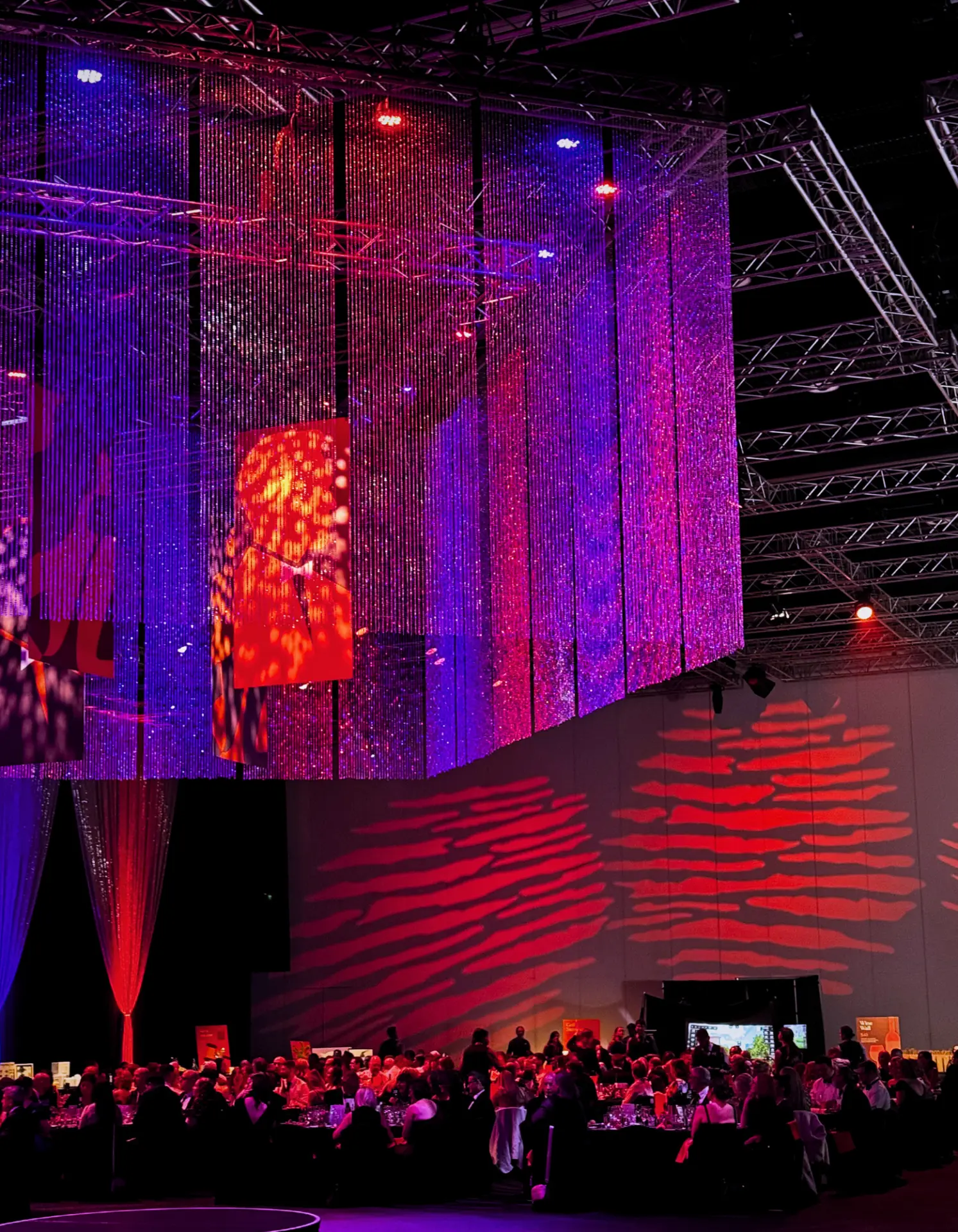 Black-tie gala awards dinner with dramatic lighting and draped LED features at a major Adelaide corporate event