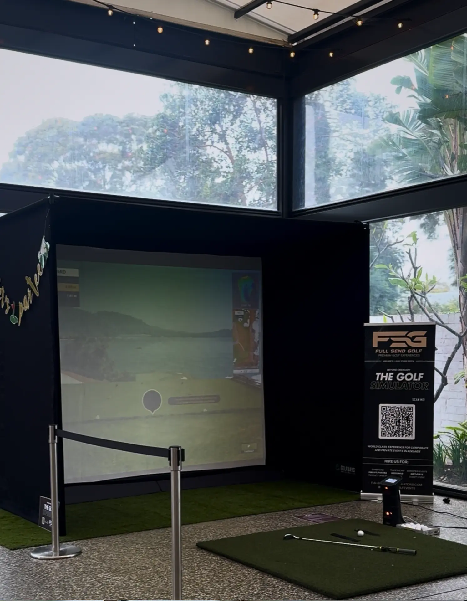 Outdoor golf simulator hire under a marquee at an Adelaide garden event with Full Send Golf signage