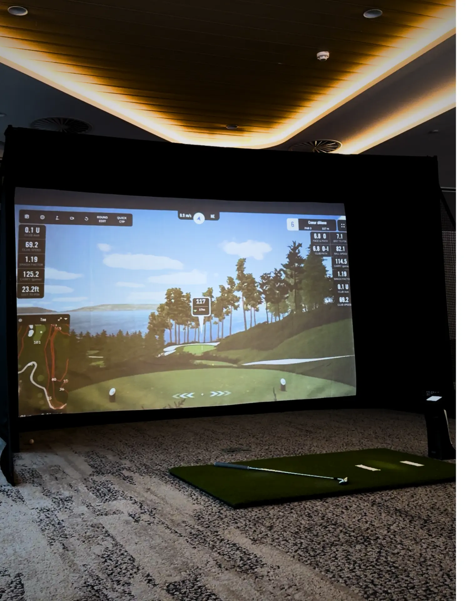 Golf simulator hire set up inside an Adelaide hotel ballroom with launch monitor screen and hitting mat ready for an event