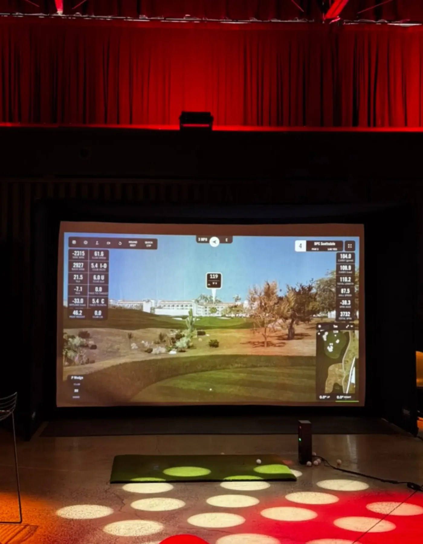 The Tee Box indoor golf simulator event setup with professional launch monitor and projection screen