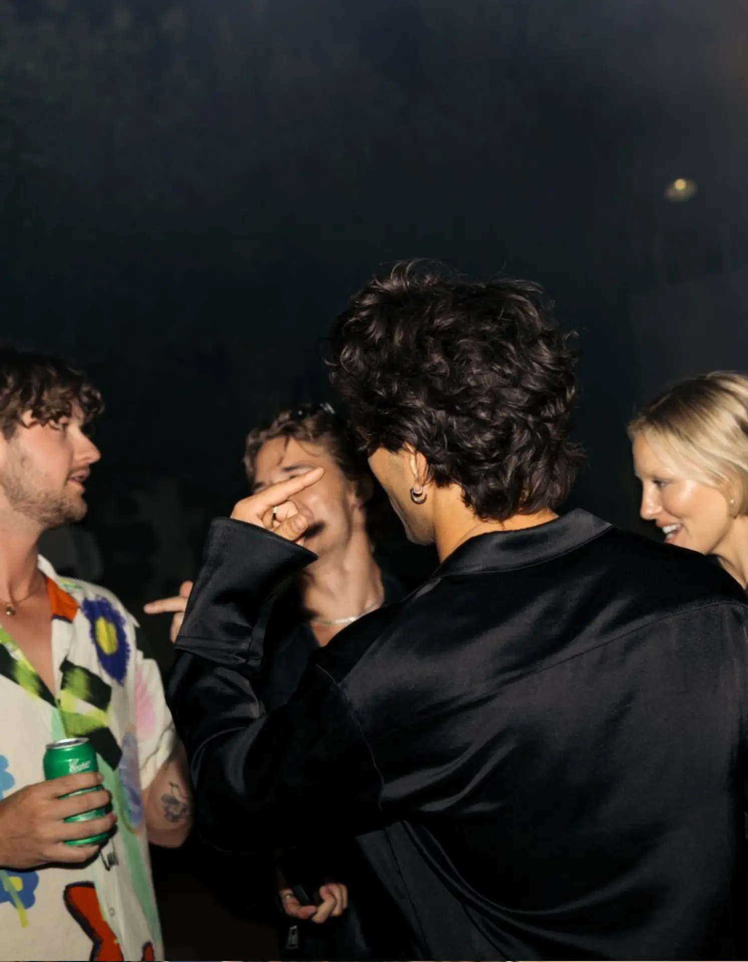 Guests laughing and socialising at a night-time golf event after party in Adelaide