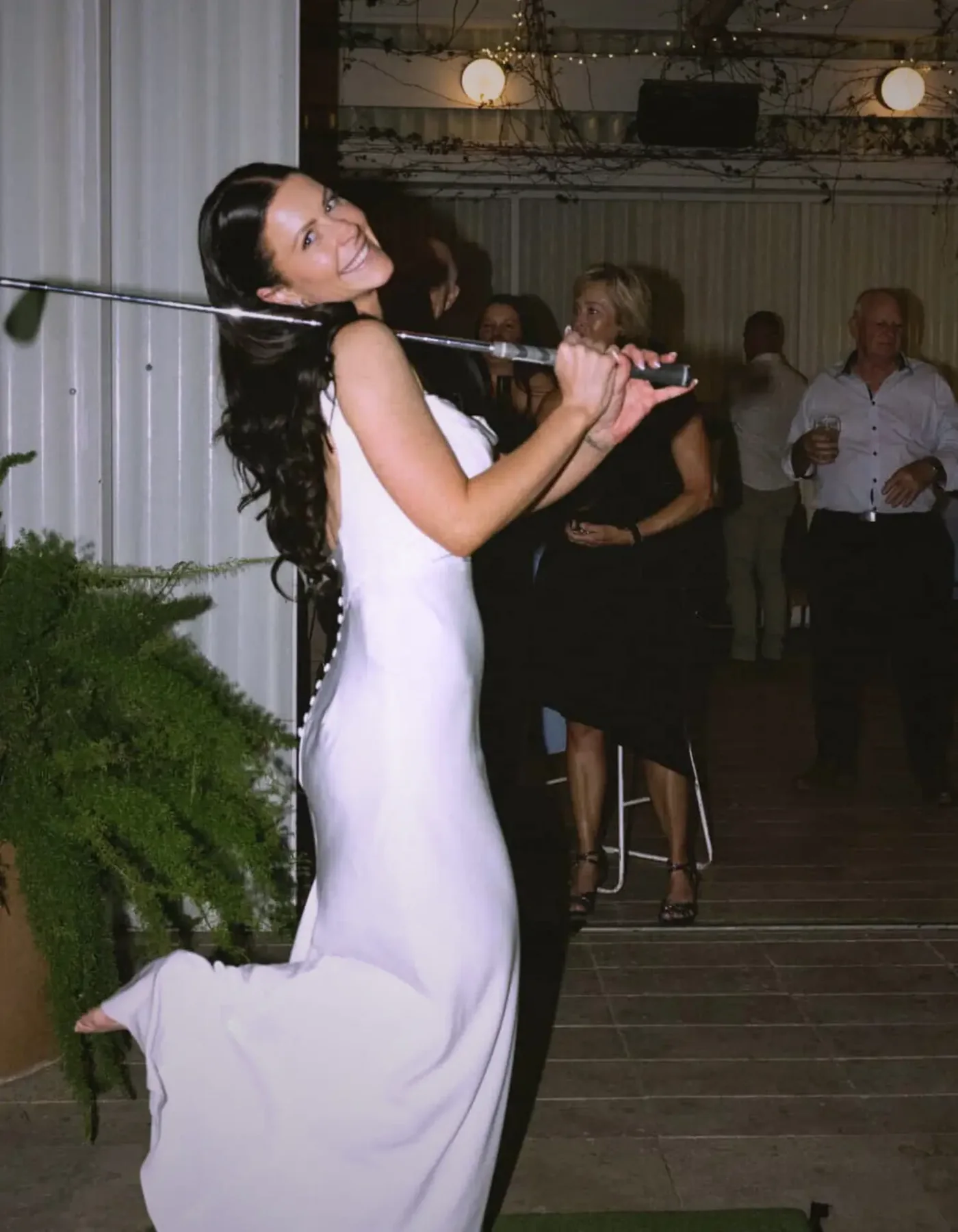 Bride enjoying The Tee Box golf simulator hire at an Adelaide wedding reception