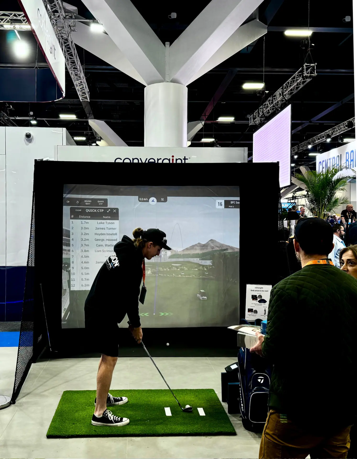 Guest putting on the Full Send golf simulator at the Convergint booth during an Adelaide trade show